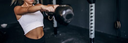 young woman working out with a kettlebell